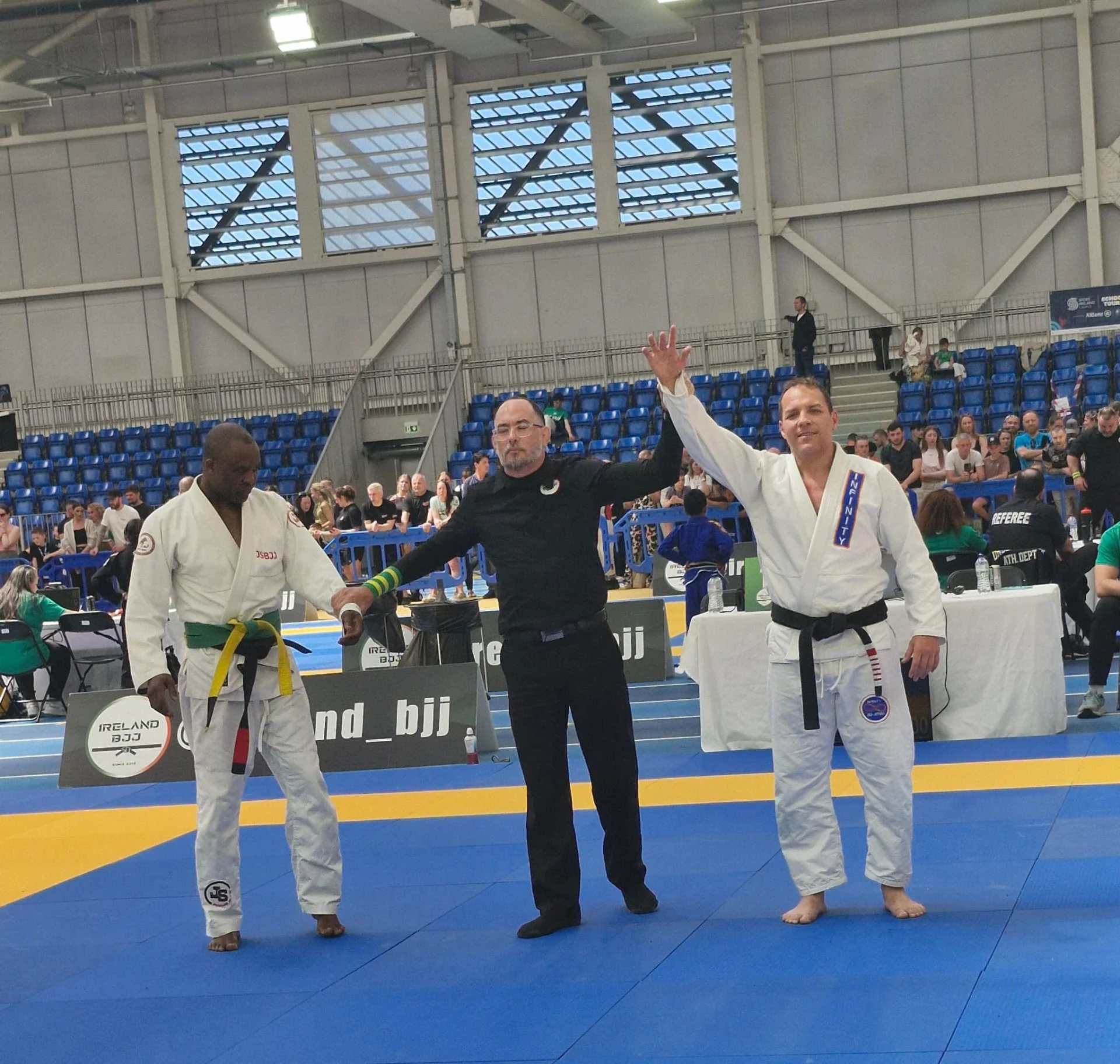 A referee raising Fabiano's arm after a match at an Irish Brazilian Jiu-Jitsu tournament, decades after the same moment in Brazil