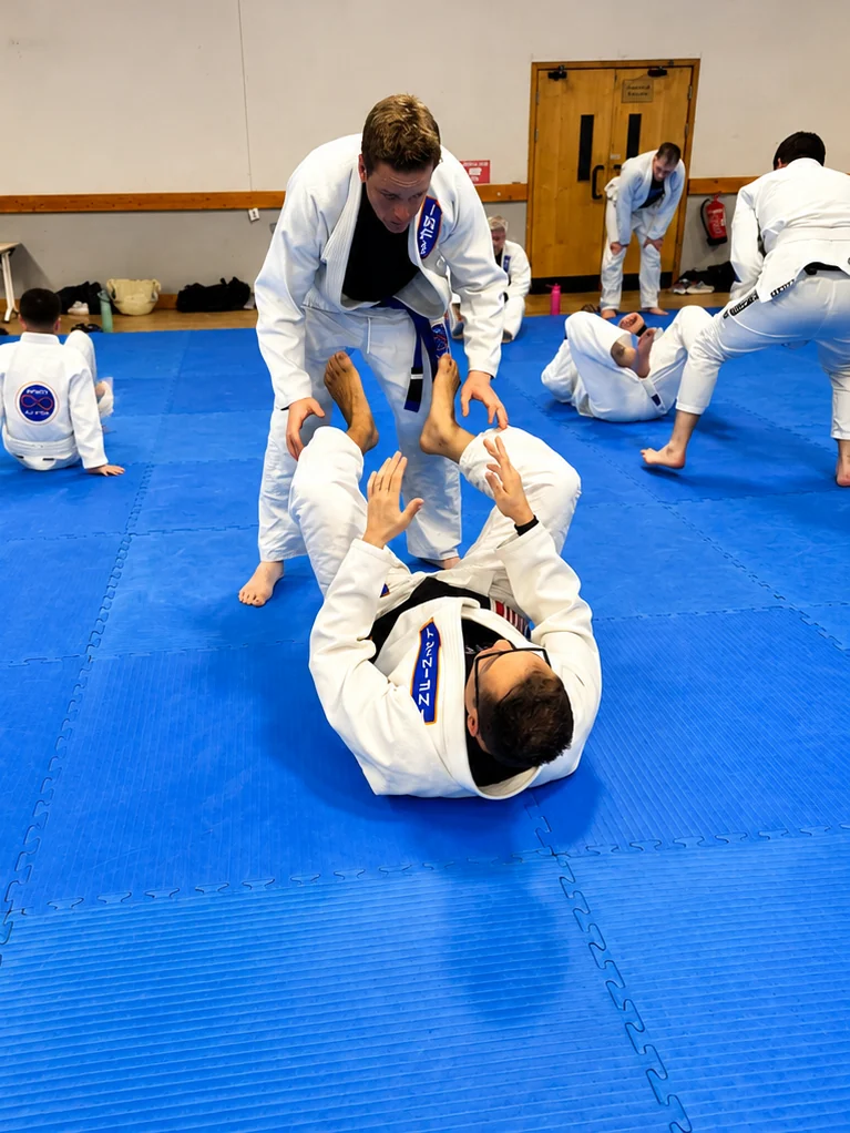 Adult students practising guard during a regular Gracie Jiu-Jitsu class at Infinity