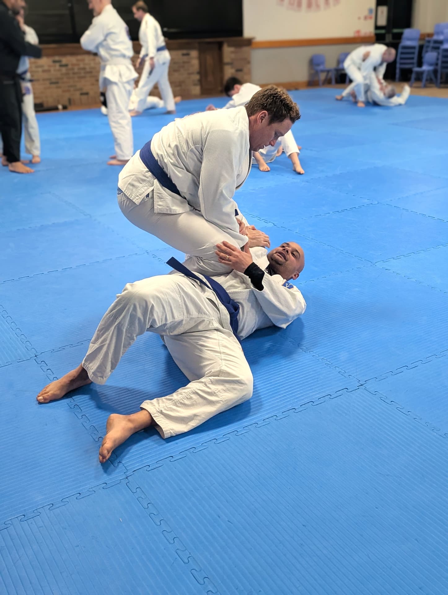 An instructor demonstrating a technique to a mixed-ability adult class