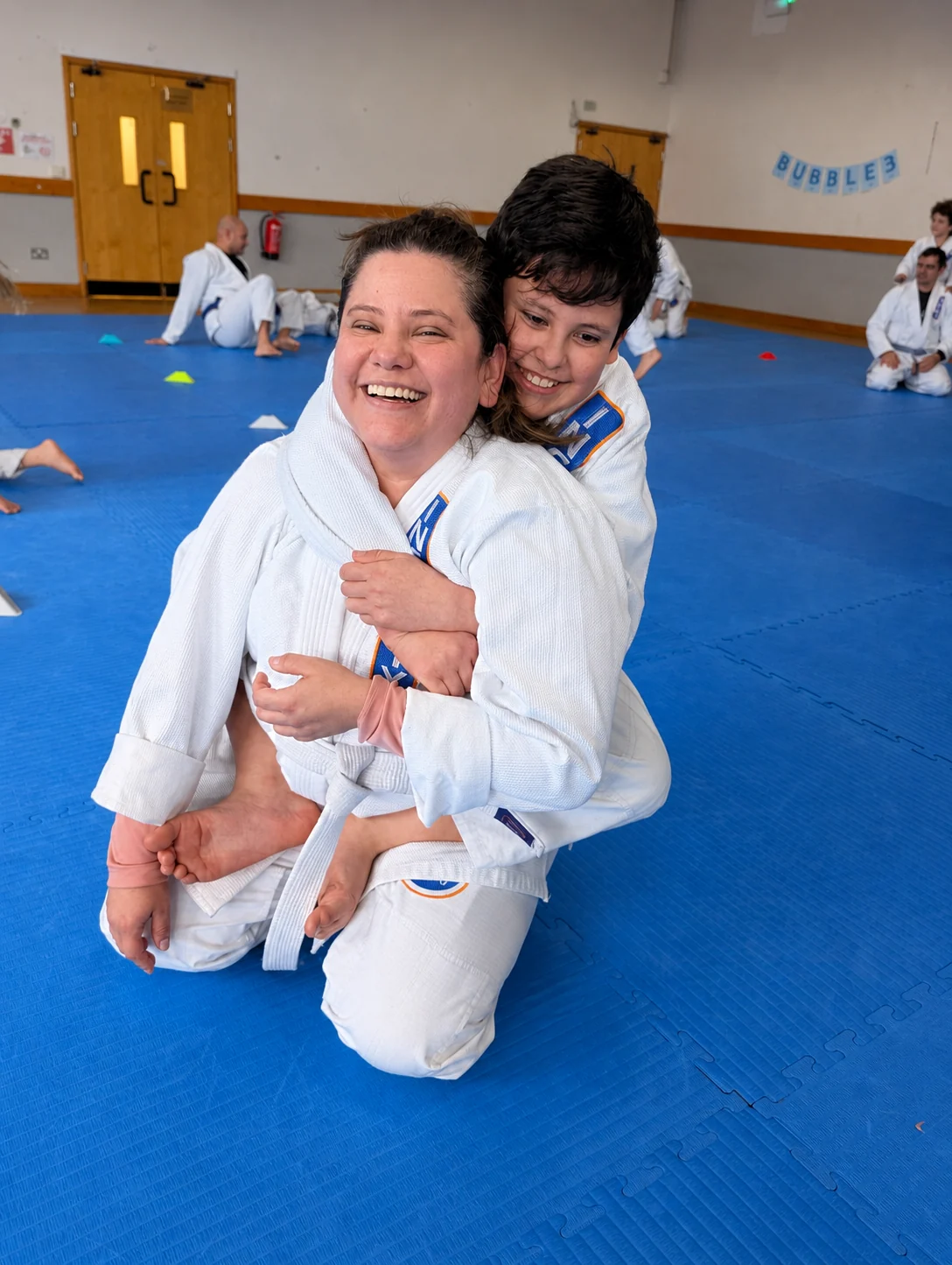 A mother and her child laughing together in Infinity gis during a Parents & Kids class